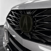 2021–2025 Acura TLX front emblem with smoked tint overlay muting the factory chrome logo