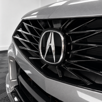 2021–2025 Acura TLX front emblem with smoked tint overlay muting the factory chrome logo