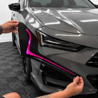 2021–2025 Acura TLX headlight with transparent pink DRL tint and gloss black amber-delete vinyl installed