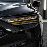 2022–2026 Acura MDX headlight with gloss black amber-delete eyelid and transparent yellow DRL tint overlay installed.