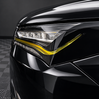 2022–2026 Acura MDX headlight with gloss black amber-delete eyelid and transparent yellow DRL tint overlay installed.