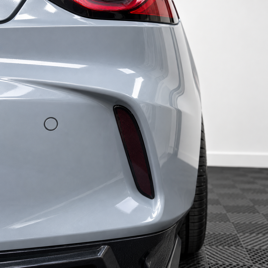 2021–2025 Acura TLX rear bumper reflector with smoked vinyl tint overlay installed