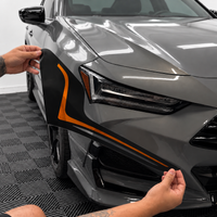 2021–2025 Acura TLX headlight with amber-orange DRL tint and gloss black amber-delete vinyl installed