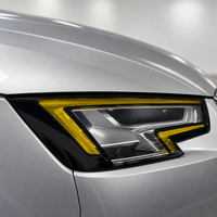 2017–2019 Audi A4 S4 B9 headlight with yellow DRL tint, gloss black eyelid, and side reflector coverage