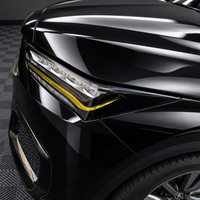 2022–2026 Acura MDX headlight with gloss black amber-delete eyelid and transparent yellow DRL tint overlay installed.