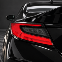 2022–2027 Subaru BRZ taillight with smoked tint vinyl overlay covering the clear turn signal section and leaving the red C-shaped lens exposed.