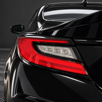 2022–2027 Subaru BRZ taillight with smoked tint vinyl overlay covering the clear turn signal section and leaving the red C-shaped lens exposed.